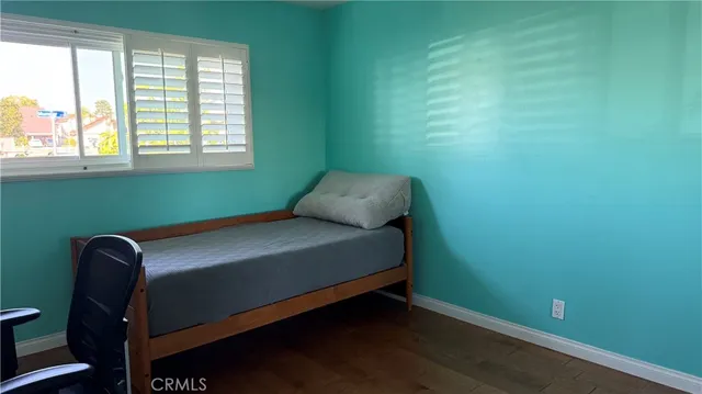 a room with a bed and windows