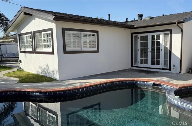 a house with swimming pool in front of it