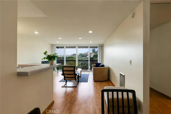 a kitchen with granite countertop white cabinets and a stove