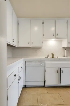 a kitchen with cabinets appliances and a sink