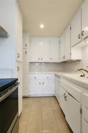 a stove top oven sitting inside of a kitchen