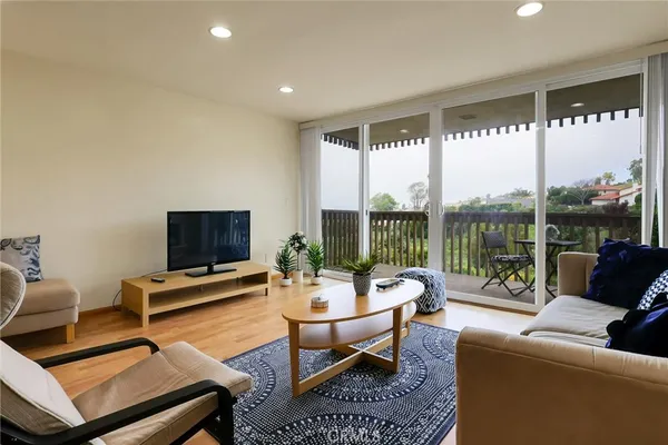 a view of a brick house with a flower plants