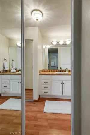 a view of a room with wooden floor and furniture