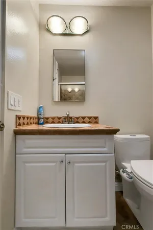 a bedroom with a bed and a lamp on dresser