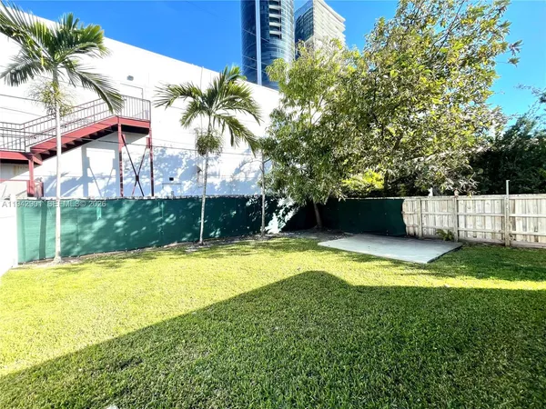 a view of a backyard with a garden and entertaining space