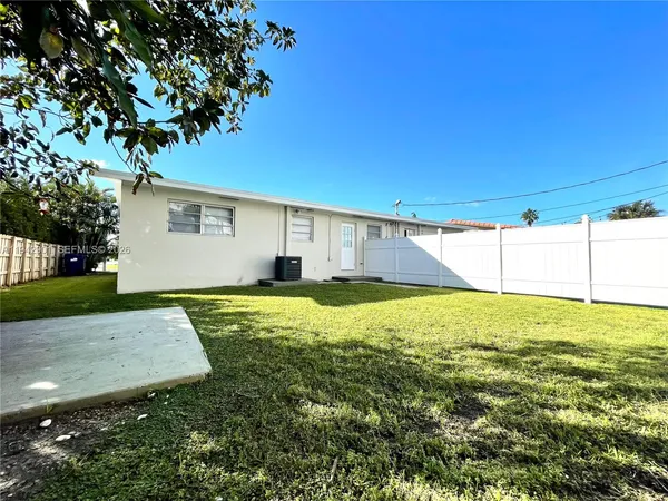 a view of a backyard with plants and a backyard