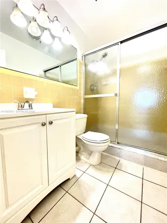a bathroom with a toilet a sink and shower