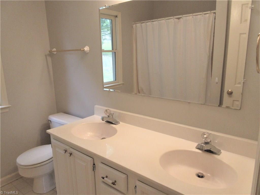 315 Canterbury Road High Point, NC 27262 - Photo 16 of 18 Hall Bathroom has Dual Sinks and Linen Closet.