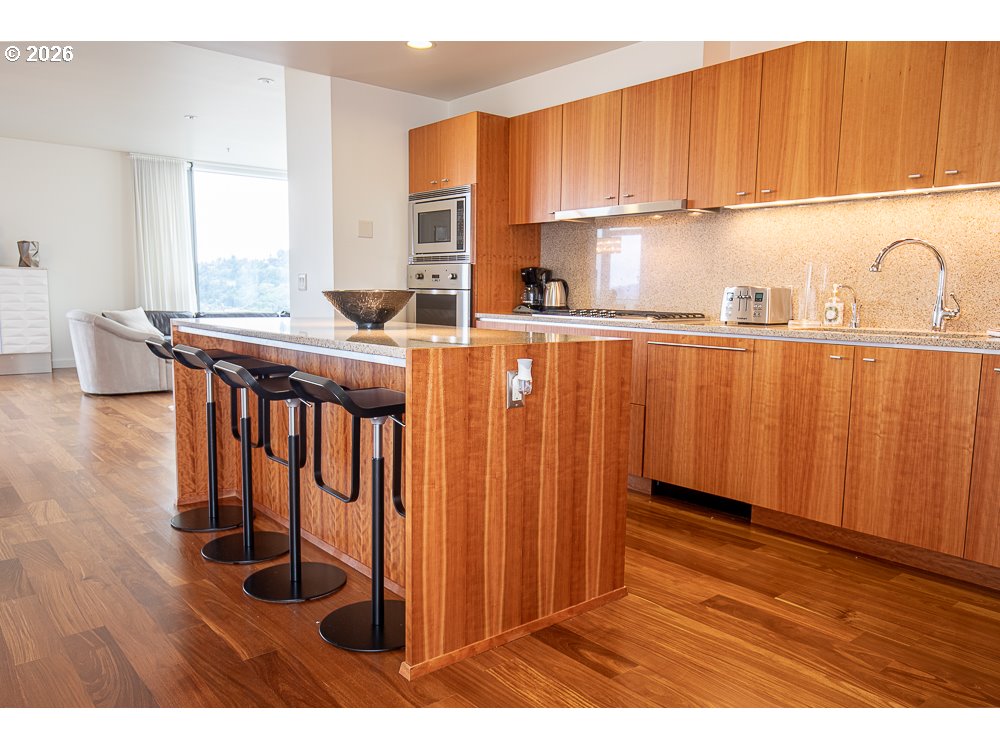 841 Southwest Gaines Street, Unit 2012 Portland, OR 97239 - Photo 18 of 44 a kitchen with wooden cabinets