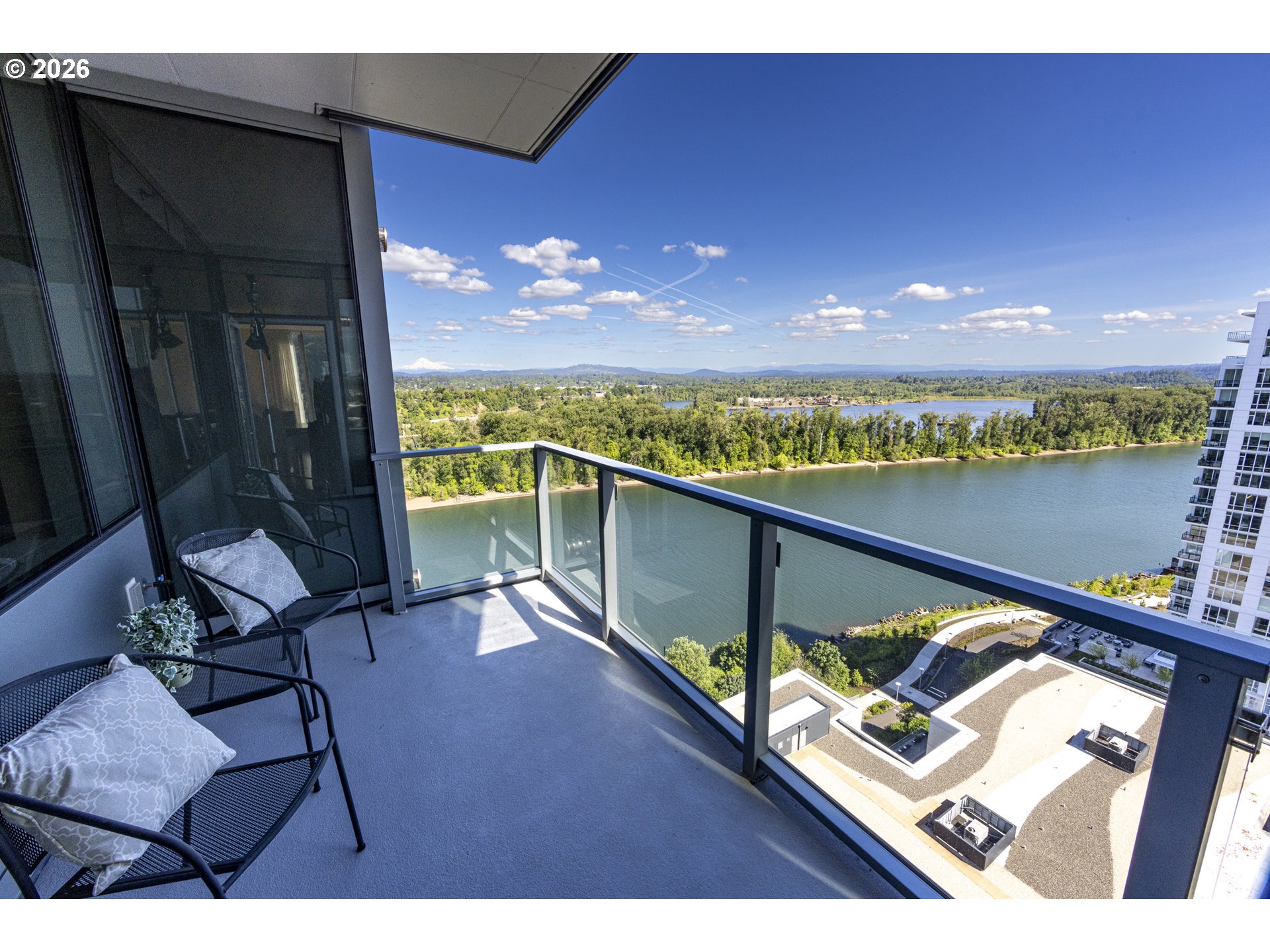 841 Southwest Gaines Street, Unit 2012 Portland, OR 97239 - Photo 2 of 44 a view of a balcony with chair and a floor to ceiling window