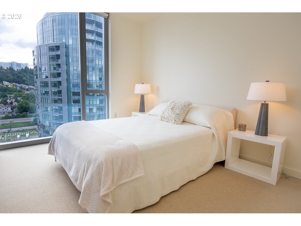 841 Southwest Gaines Street, Unit 2012 Portland, OR 97239 - Photo 24 of 44 a large white bed in a bedroom next to a window