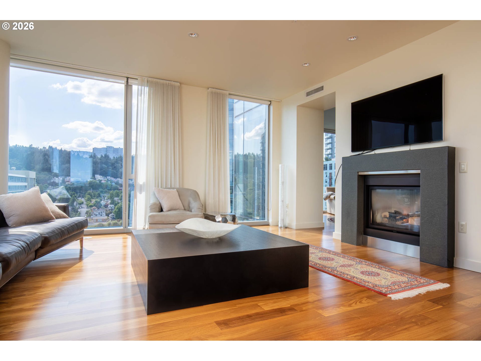 841 Southwest Gaines Street, Unit 2012 Portland, OR 97239 - Photo 7 of 44 a living room with furniture fireplace and flat screen tv