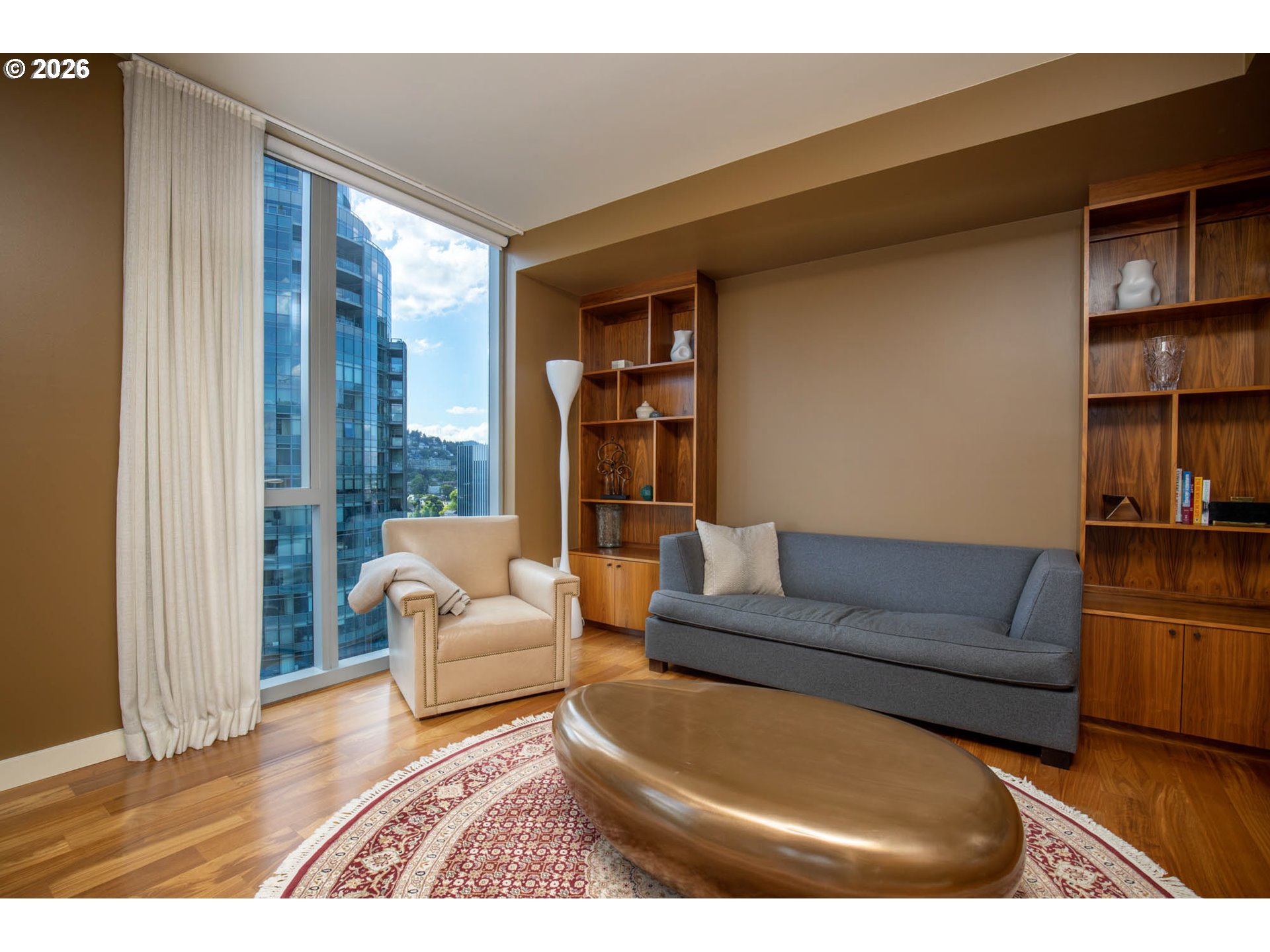 841 Southwest Gaines Street, Unit 2012 Portland, OR 97239 - Photo 9 of 44 a living room with furniture and a floor to ceiling window