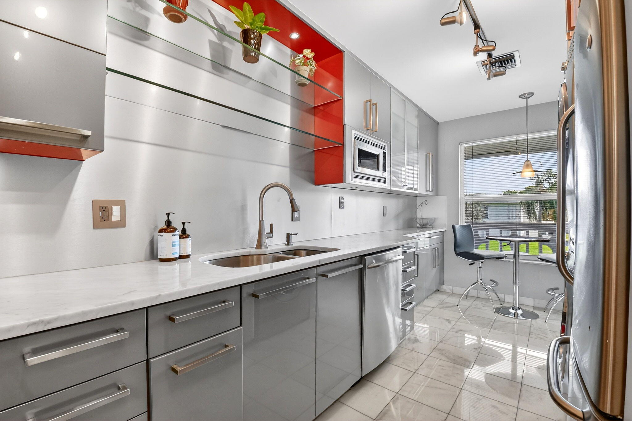 1411 Southwest 27th Avenue, Unit 201 Delray Beach, FL 33445 - Photo 11 of 48 a kitchen with a sink and cabinets