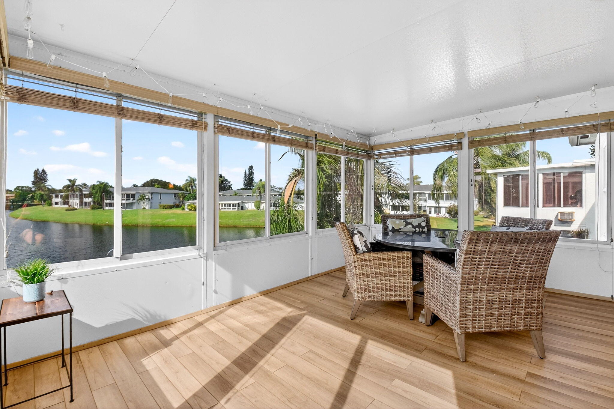 1411 Southwest 27th Avenue, Unit 201 Delray Beach, FL 33445 - Photo 17 of 48 a living room with couch and a floor to ceiling window