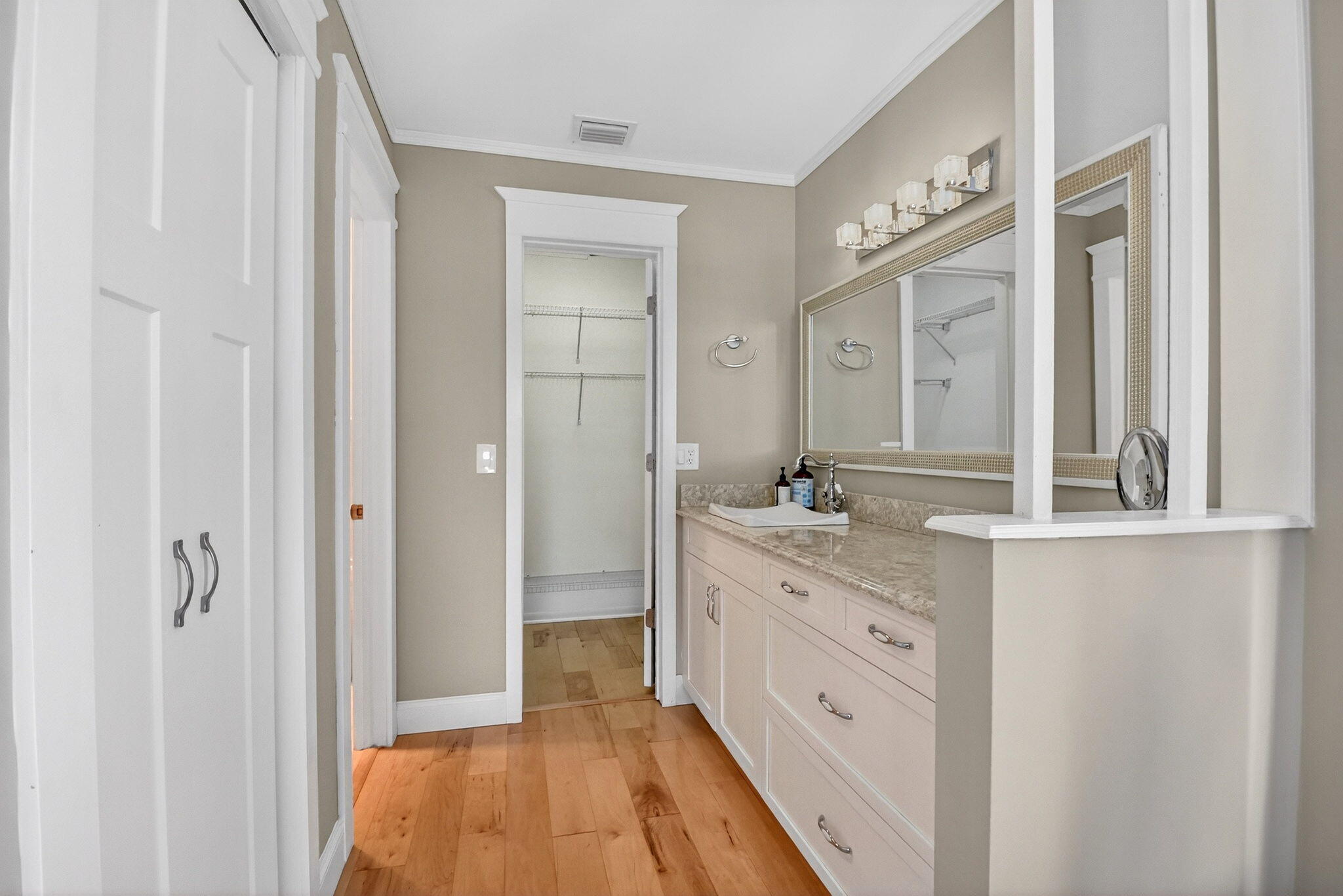 1411 Southwest 27th Avenue, Unit 201 Delray Beach, FL 33445 - Photo 20 of 48 a spacious bathroom with a granite countertop sink mirror and a