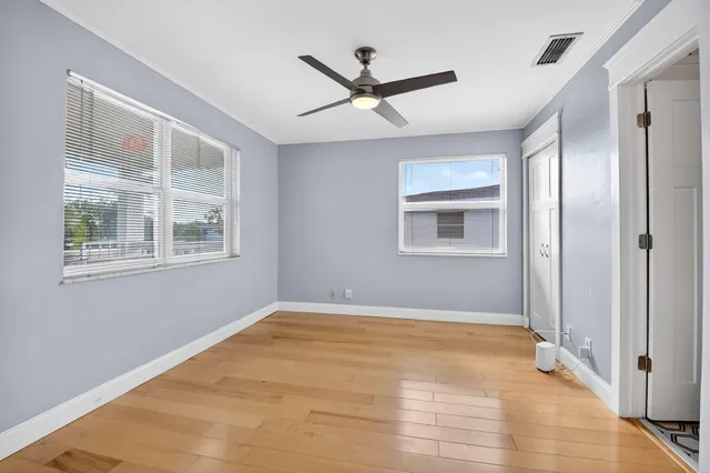 a group of people sitting in a room with kitchen view