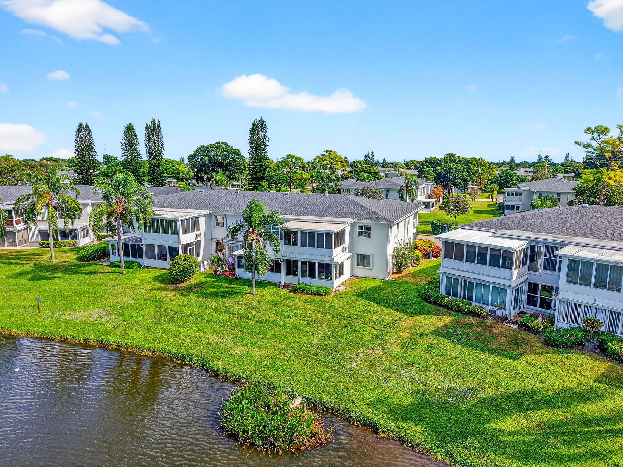 1411 Southwest 27th Avenue, Unit 201 Delray Beach, FL 33445 - Photo 34 of 48 a aerial view of a house with swimming pool and a yard