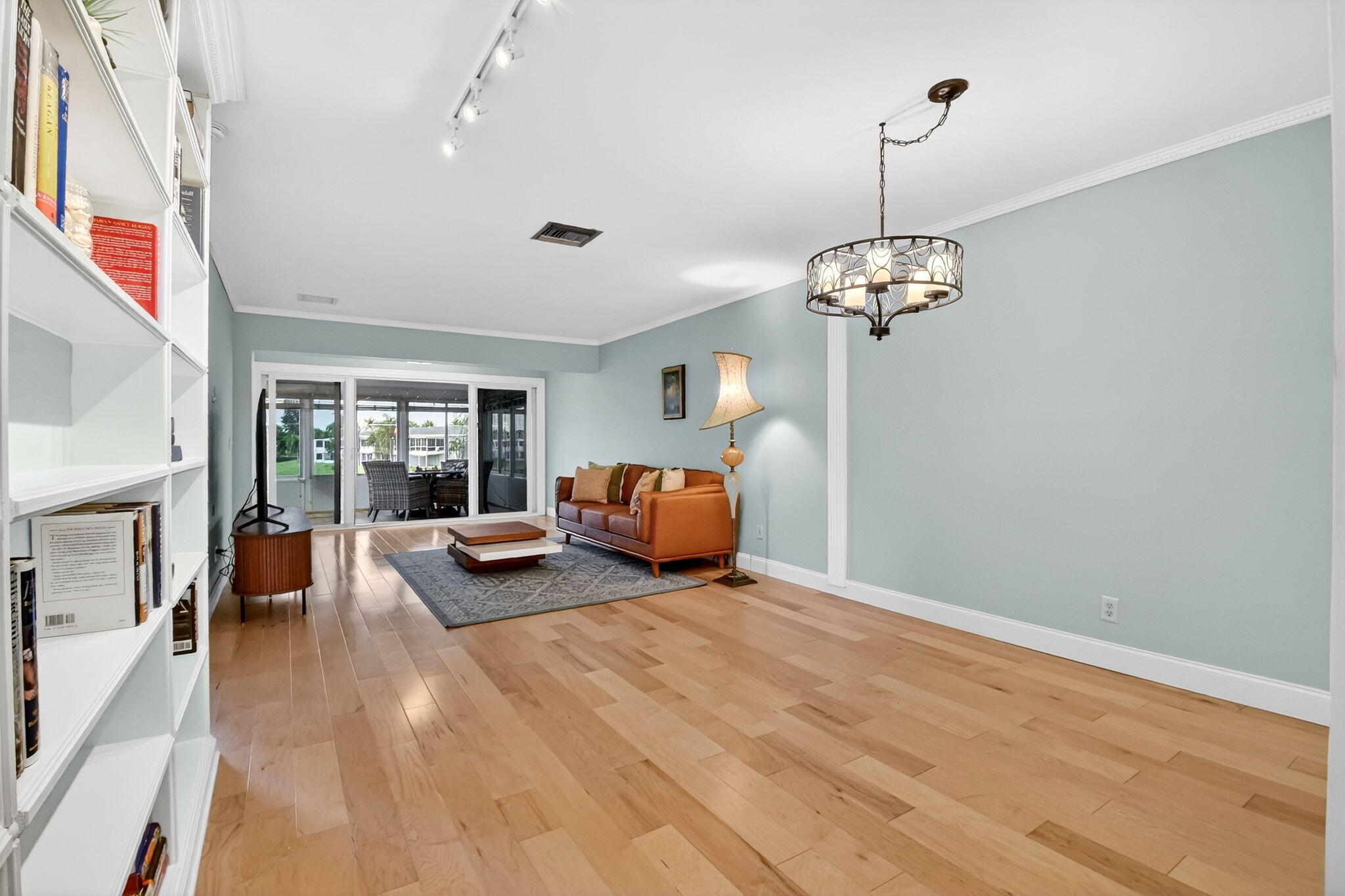 1411 Southwest 27th Avenue, Unit 201 Delray Beach, FL 33445 - Photo 6 of 48 a bed room with furniture and a chandelier