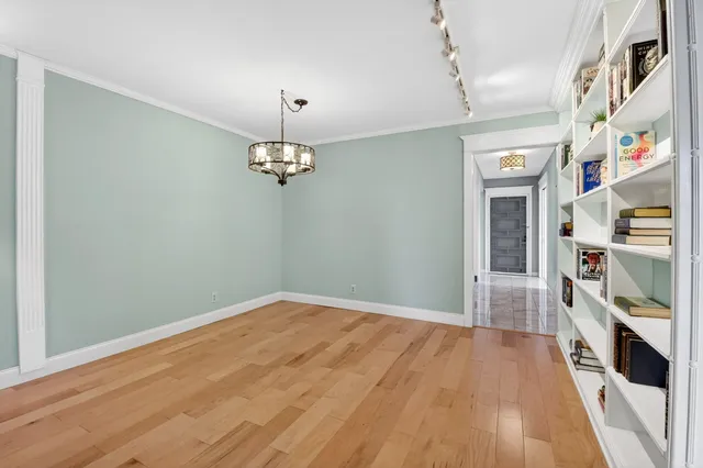 a kitchen with stainless steel appliances kitchen island granite countertop a table and chairs in it