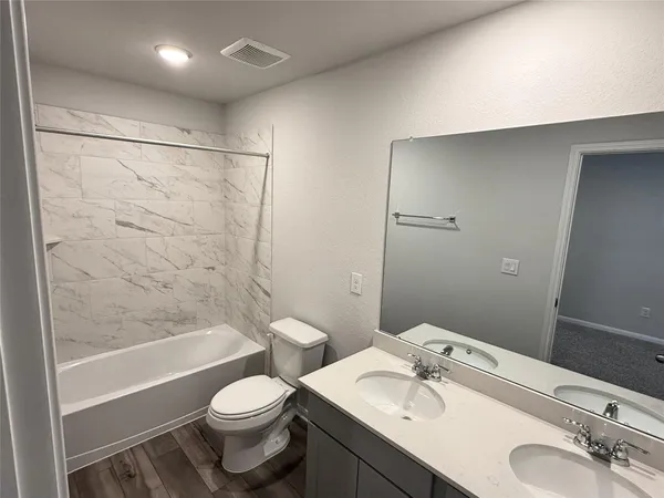 a bathroom with a toilet and a sink