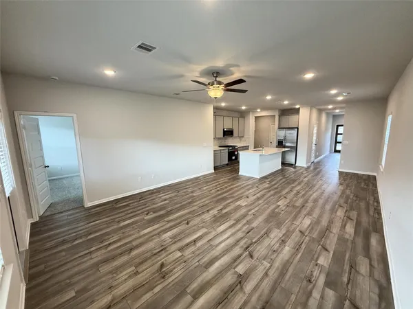 a view of a kitchen with a sink and wooden floor
