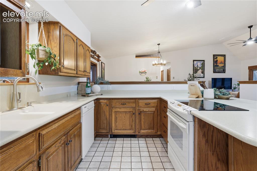 18190 Forest View Road Monument, CO 80132 - Photo 16 of 50 a kitchen with a sink stove and cabinets