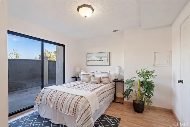 a bedroom with a bed and a potted plant