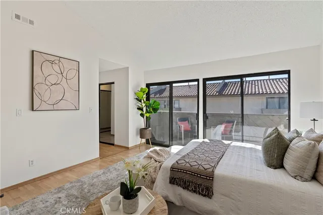 a bedroom with furniture and a large window