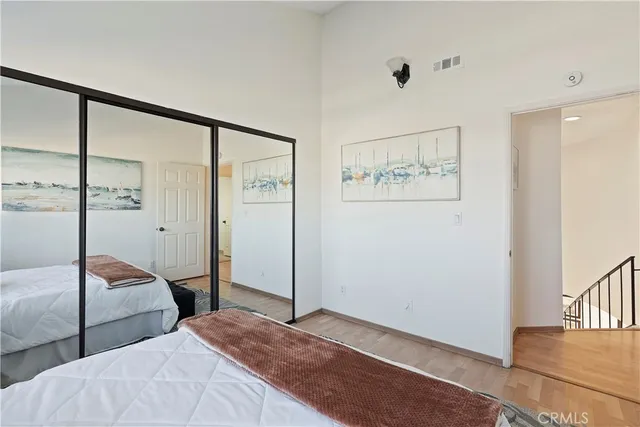 a bedroom with two beds and a painting on the wall