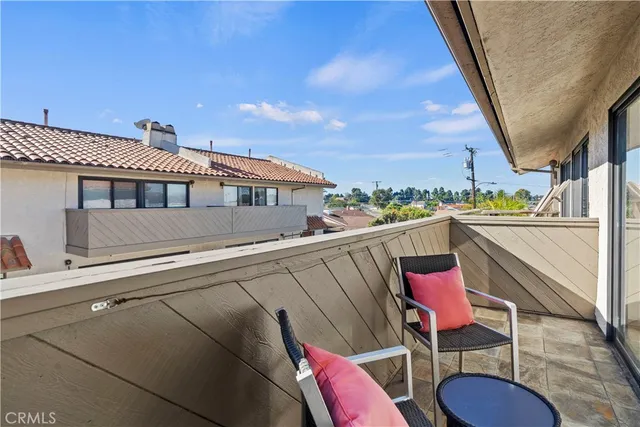 a balcony with table and chairs