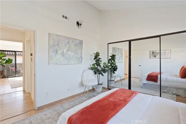 a bedroom with furniture and a potted plant