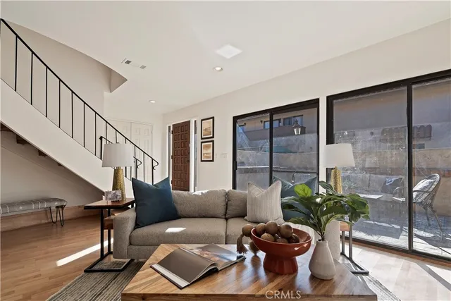 a living room with furniture flowerpot and wooden floor