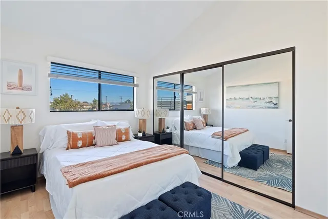 a bedroom with a bed and large window