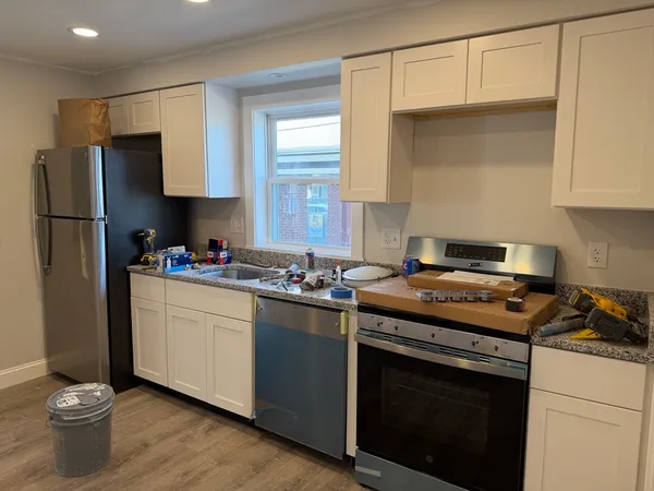 a kitchen with a stove and a refrigerator
