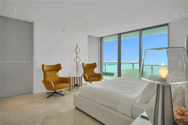 a bedroom with a bed and a chair