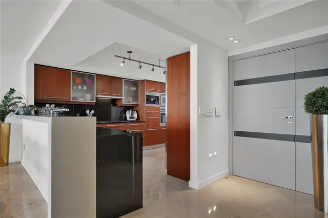 a bathroom with a shower sink vanity and toilet