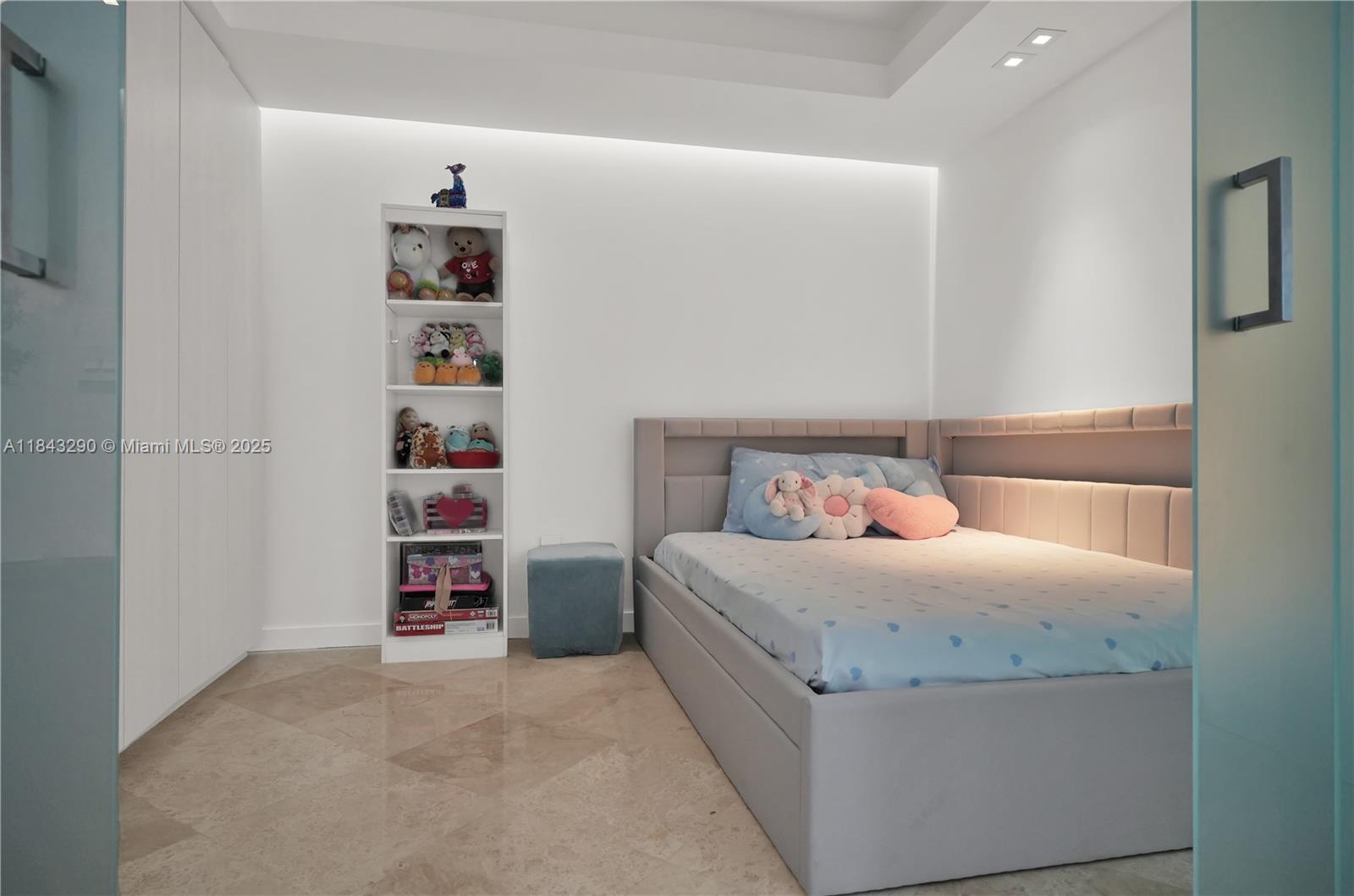 1331 Brickell Bay Drive, Unit 4303 Miami, FL 33131 - Photo 24 of 41 a bedroom with a bed and a book shelf