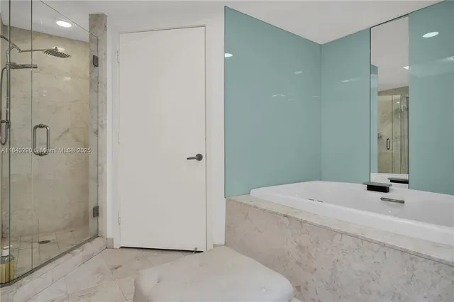 a bathroom with a granite countertop sink a toilet and shower