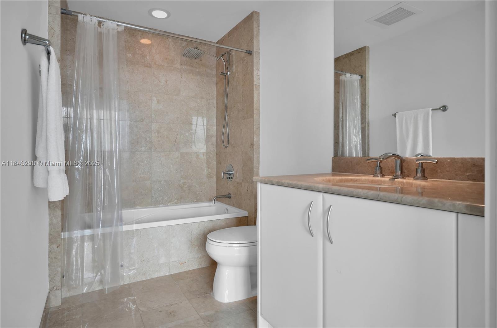 1331 Brickell Bay Drive, Unit 4303 Miami, FL 33131 - Photo 26 of 41 a bathroom with a granite countertop sink a toilet and shower
