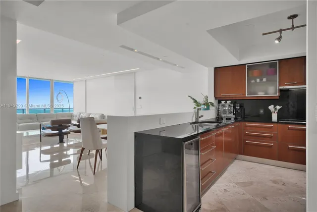 a kitchen with stainless steel appliances granite countertop sink stove and cabinets