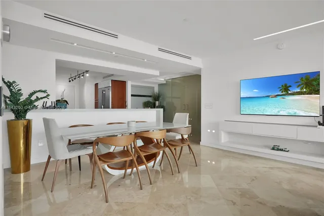 a view of a dining room with furniture and a potted plant