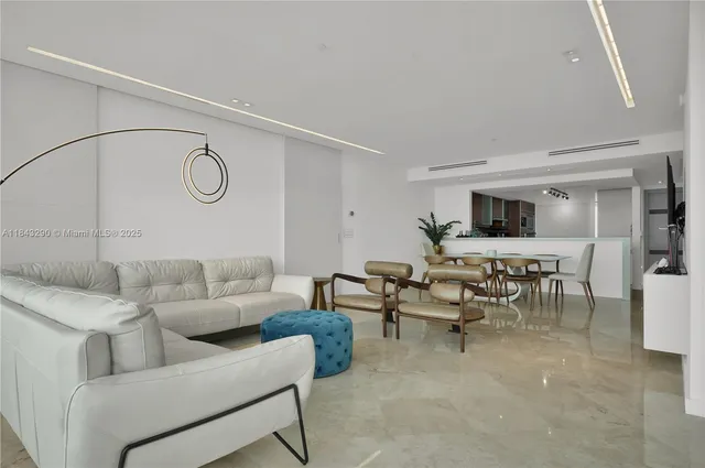a living room with furniture and a clock