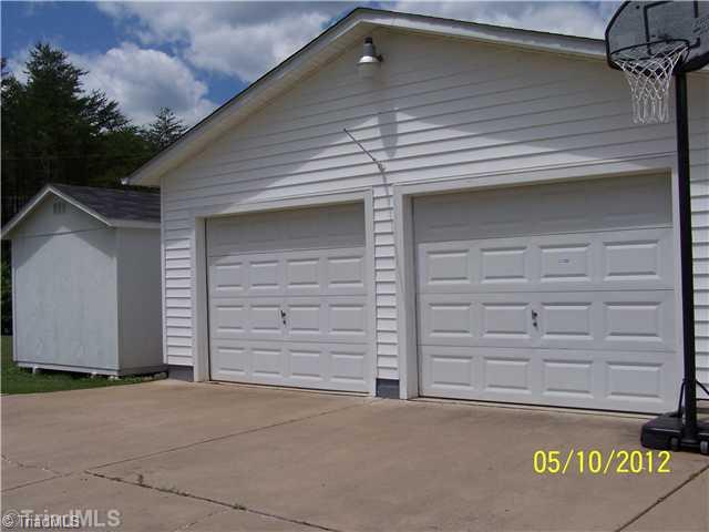 1166 Ridge Road Pine Hall, NC 27042 - Photo 3 of 16 Parking Lot/Garage. Concrete drive to 2 car garage in back of house