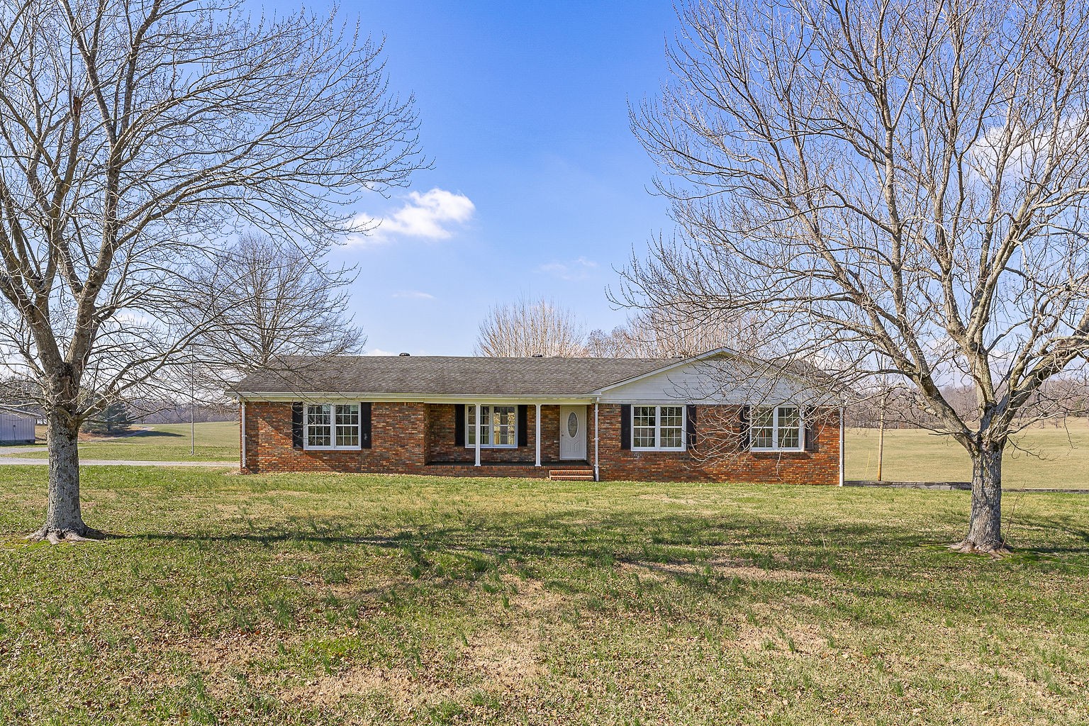 6401 Lucky Road McMinnville, TN 37110 - Photo 2 of 50 a front view of a building with a yard