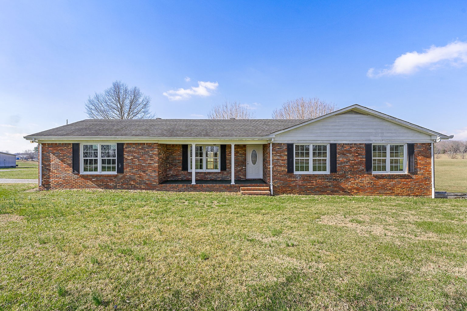 6401 Lucky Road McMinnville, TN 37110 - Photo 22 of 50 a front view of a house with a garden