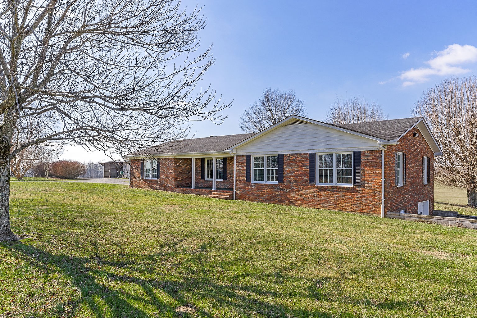 6401 Lucky Road McMinnville, TN 37110 - Photo 23 of 50 a front view of a house with a garden