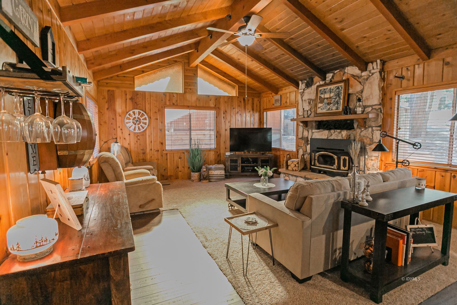 52507 Sylvan Way Idyllwild, CA 92549 - Photo 10 of 43 a living room with furniture a flat screen tv and a fireplace