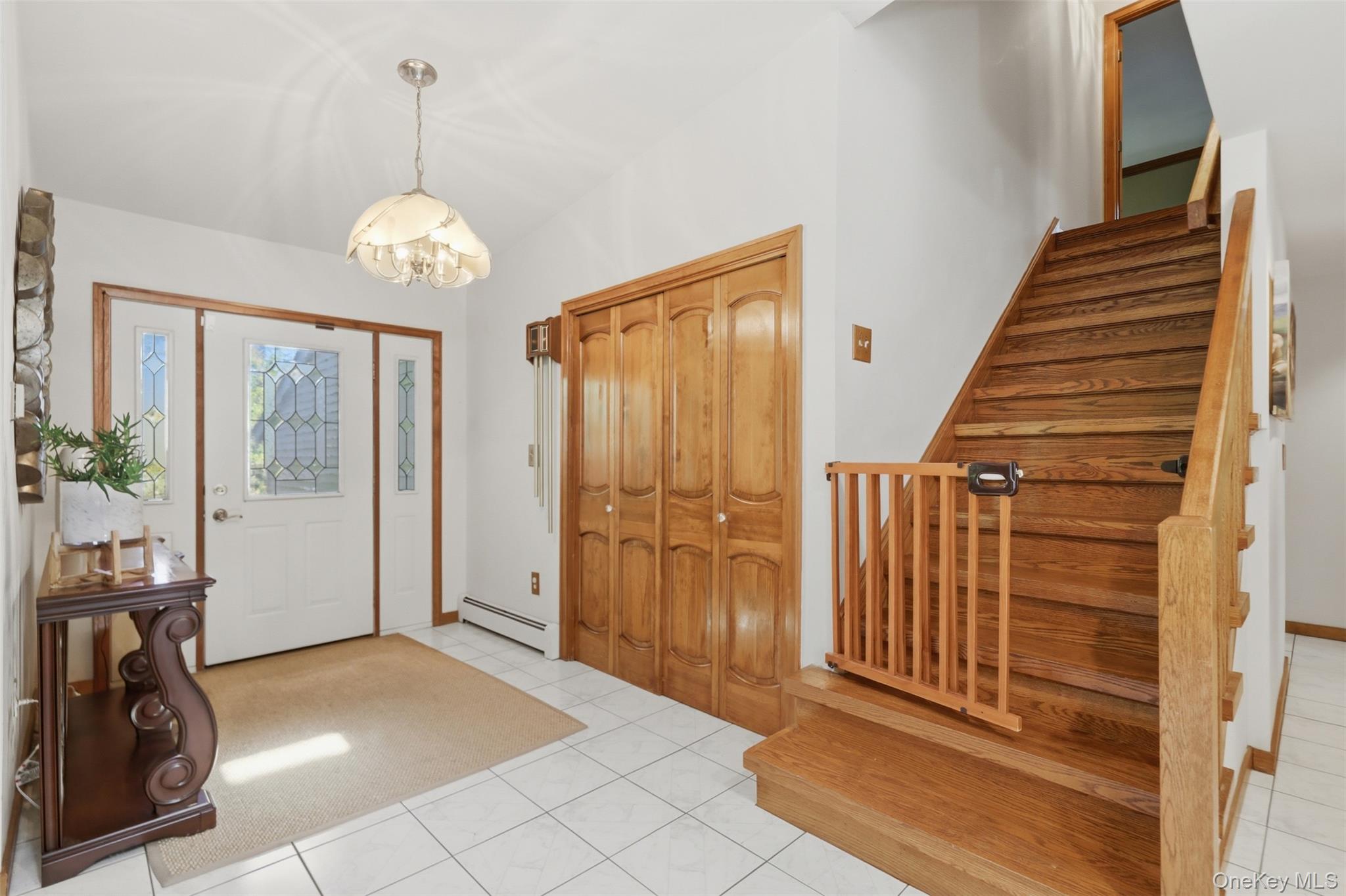 985 Craigville Road Chester, NY 10918 - Photo 4 of 36 Entryway featuring white tile flooring and a light fixture with frosted glass shades