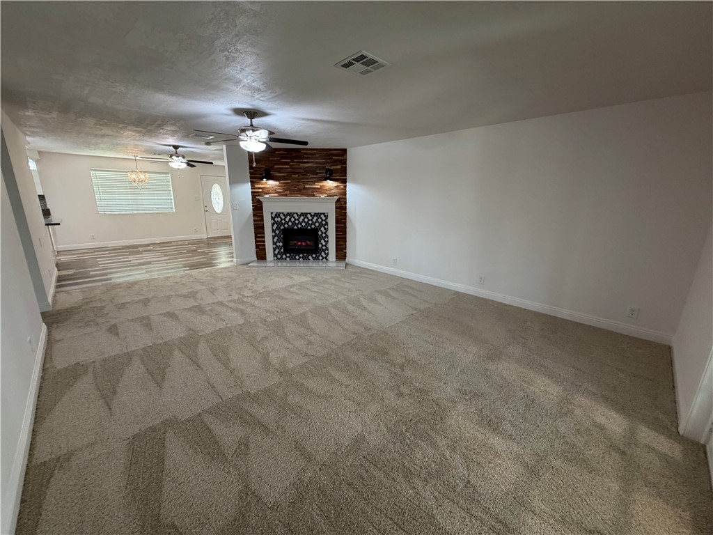 1985 Laguna Road Mohave Valley, AZ 86440 - Photo 21 of 83 Unfurnished living room with a fireplace and light carpet